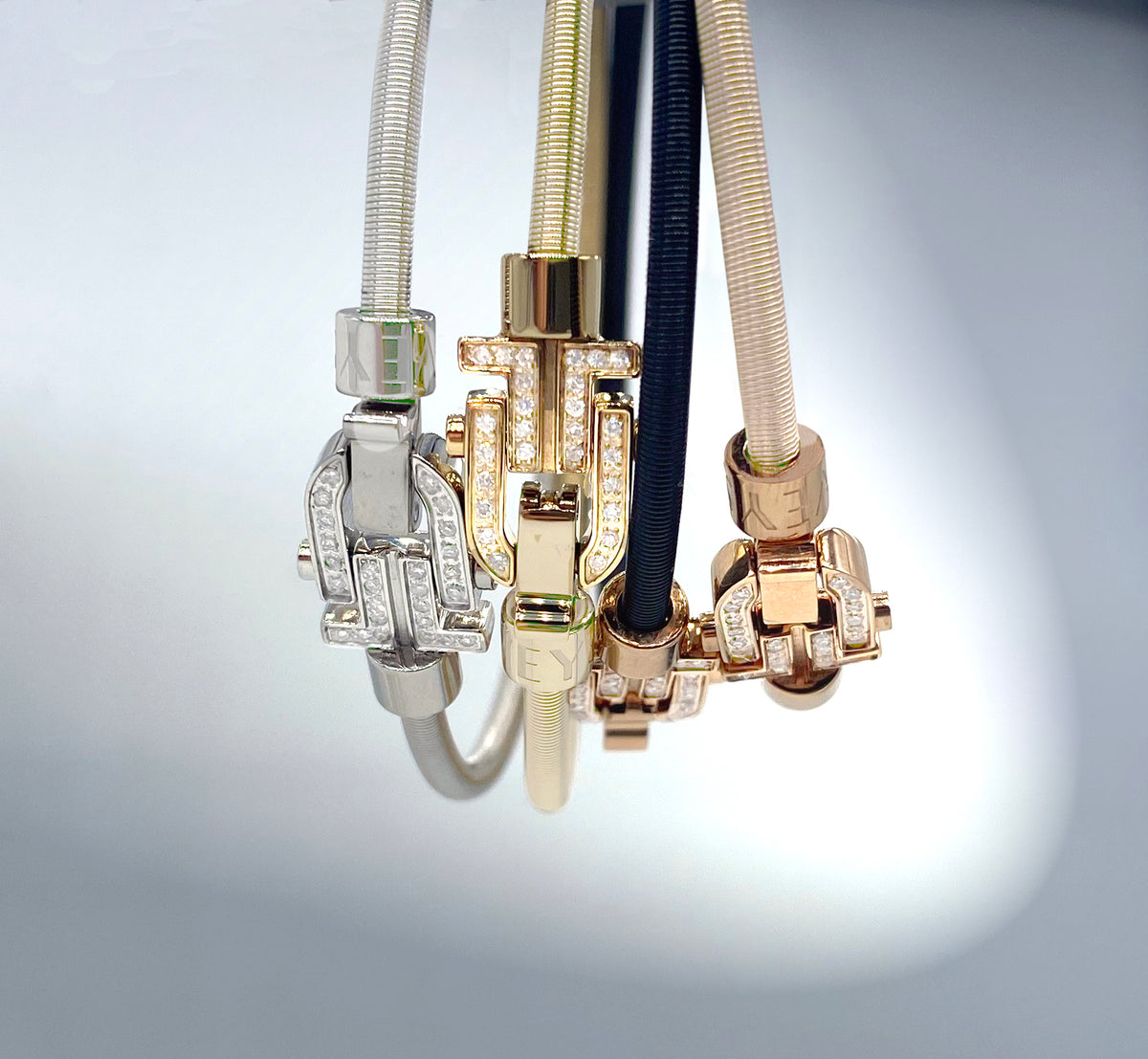 The Diapason motifs of four VEYS bracelets in silver, gold and rose tones