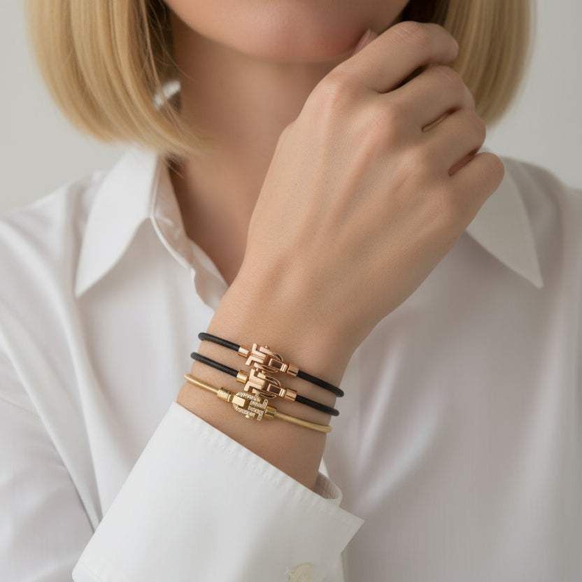 Black and gold-tone VIBES bracelets worn with a white shirt