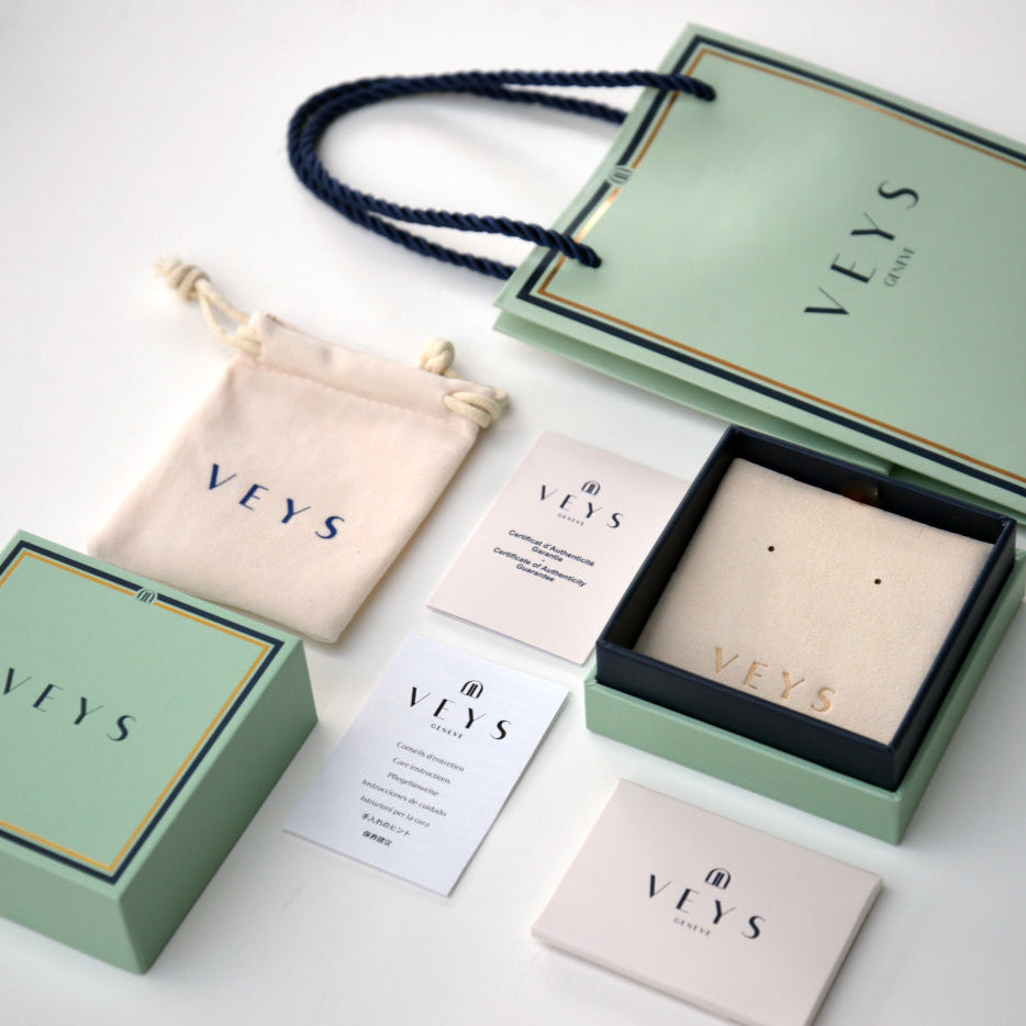 VEYS branded packaging including boxes, bags, and cards on a white background